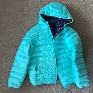 Blue puffer jacket with different colored print on the inside
